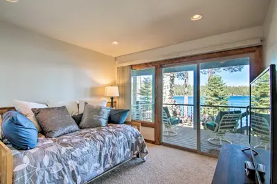 a bedroom with a bed and a balcony with a view at Hot Tub and Lake Tahoe Views Waterfront Retreat in Tahoma