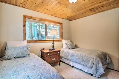 a bedroom with two beds and a window at Hot Tub and Lake Tahoe Views Waterfront Retreat in Tahoma