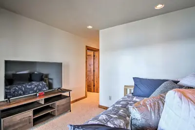 a living room with a couch and a flat screen tv at Hot Tub and Lake Tahoe Views Waterfront Retreat in Tahoma