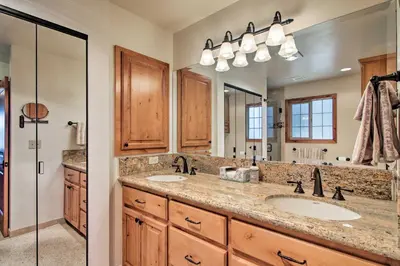 a bathroom with two sinks and a large mirror at Hot Tub and Lake Tahoe Views Waterfront Retreat in Tahoma