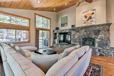 a living room with a couch and a fireplace at Truckee Escape with Hot Tub Near Ski Resorts in Truckee