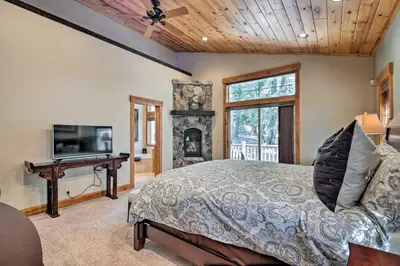 a bedroom with a bed and a tv and a fireplace at Truckee Escape with Hot Tub Near Ski Resorts in Truckee