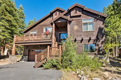 a log house with a porch and a deck at Truckee Escape with Hot Tub Near Ski Resorts in Truckee