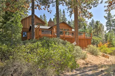 a log home in the woods with trees at Hot Tub and Lake Tahoe Views Kings Beach Lodge in Kings Beach