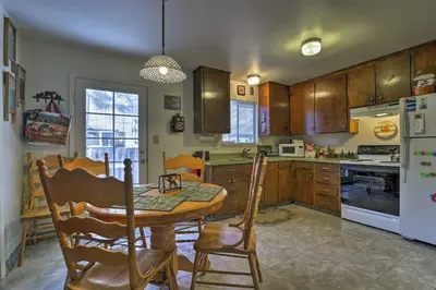 a kitchen with a table and chairs and a refrigerator at Home 1 Mi to Heavenly Mtn Resort! Unwind Fireside in South Lake Tahoe