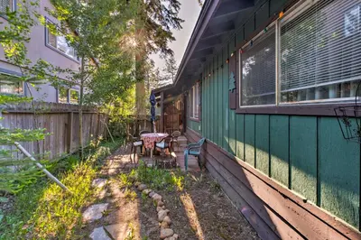 a green house with a table and a window at Home 1 Mi to Heavenly Mtn Resort! Unwind Fireside in South Lake Tahoe