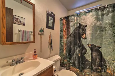 a bathroom with a shower curtain of a bear and a dog at Home 1 Mi to Heavenly Mtn Resort! Unwind Fireside in South Lake Tahoe