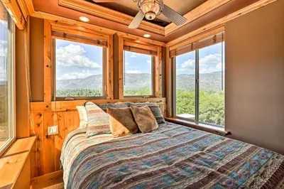a bedroom with a bed in a room with windows at 28 Mi to Yosemite Lovely Mtn Cottage with Deck! in North Fork