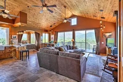 a living room with a couch and a table at 28 Mi to Yosemite Lovely Mtn Cottage with Deck! in North Fork