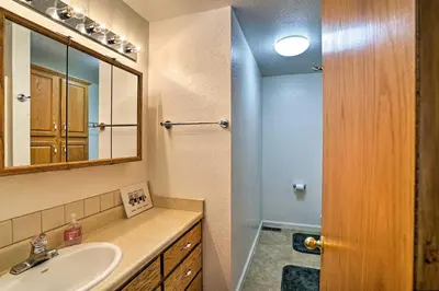 a bathroom with a sink and a mirror at 4 Mi to Heavenly Home with Deck in South Lake Tahoe in South Lake Tahoe