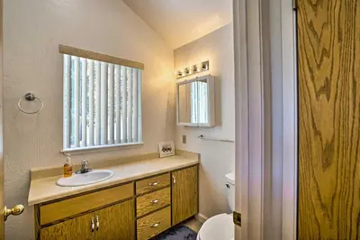 a bathroom with a sink and a toilet and a window at 4 Mi to Heavenly Home with Deck in South Lake Tahoe in South Lake Tahoe
