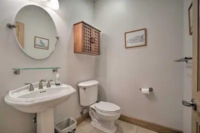 a bathroom with a sink and a toilet and a mirror at 9 Mi to Heavenly Mountain South Lake Tahoe Home! in South Lake Tahoe