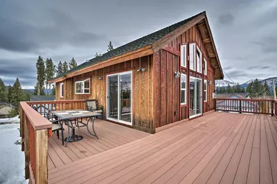 a wooden deck with a picnic table on a house at 9 Mi to Heavenly Mountain South Lake Tahoe Home! in South Lake Tahoe