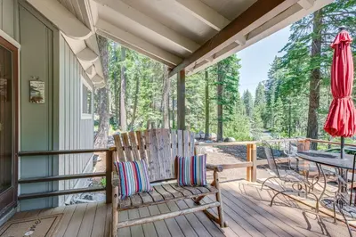 a porch with a rocking chair and a table at Private Mountain Retreat 8 Mi to Lake Tahoe! in South Lake Tahoe