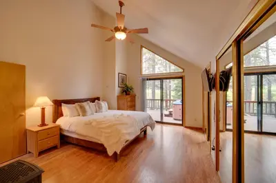 a bedroom with a bed and a ceiling fan at Truckee Home with Private Hot Tub on a Golf Course in Truckee