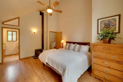 a bedroom with a bed and a ceiling fan at Truckee Home with Private Hot Tub on a Golf Course in Truckee