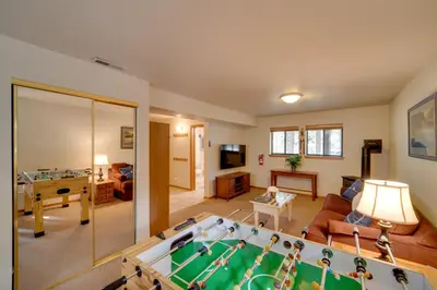 a living room with a pool table in the middle at Truckee Home with Private Hot Tub on a Golf Course in Truckee