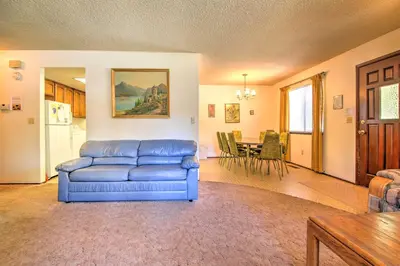 a living room with a blue couch and a table at Hike, Bike and Ski South Lake Tahoe Retreat in South Lake Tahoe