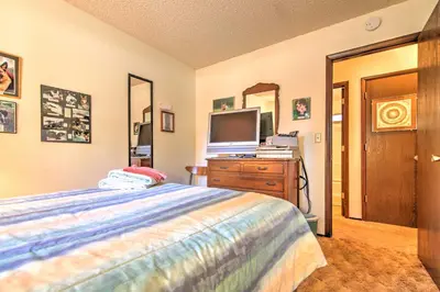 a bedroom with a bed and a tv on a dresser at Hike, Bike and Ski South Lake Tahoe Retreat in South Lake Tahoe