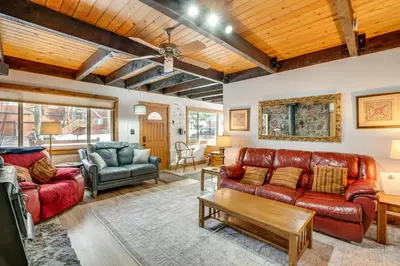 a living room with a couch and a table at 11 Mi to Ski Resorts! Lake Tahoe Gem with Pool Table in South Lake Tahoe