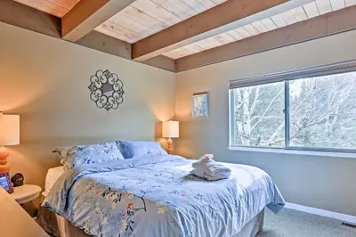 a bedroom with a bed and a window at 1 Mi to Shore Quiet South Lake Tahoe Condo in South Lake Tahoe