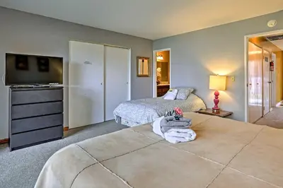 a bedroom with two beds and a dresser in it at 1 Mi to Shore Quiet South Lake Tahoe Condo in South Lake Tahoe