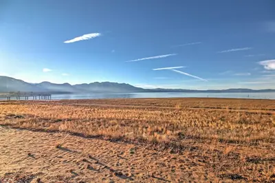 a beach with a pier and a body of water at 1 Mi to Shore Quiet South Lake Tahoe Condo in South Lake Tahoe