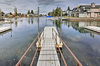a dock in a body of water with houses at 1 Mi to Shore Quiet South Lake Tahoe Condo in South Lake Tahoe