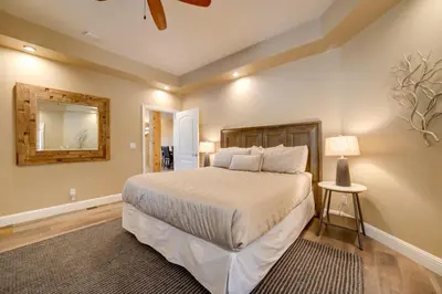 a bedroom with a large bed and a mirror at 4 Mi to Ski Mt Rose Sleek Reno-Lake Tahoe Home in Reno
