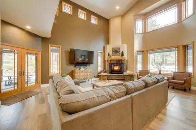 a living room with a large couch and a fireplace at 4 Mi to Ski Mt Rose Sleek Reno-Lake Tahoe Home in Reno