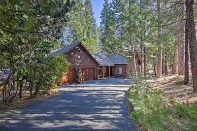 a road leading to a cabin in the woods at 5 Mi to Hiking Custom Cabin with Deck in Arnold! in Arnold