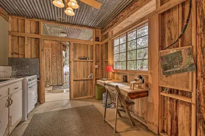a kitchen with wooden walls and a wooden counter top at Creekside Cabin 8 Mi to Kings Canyon National Park in Miramonte