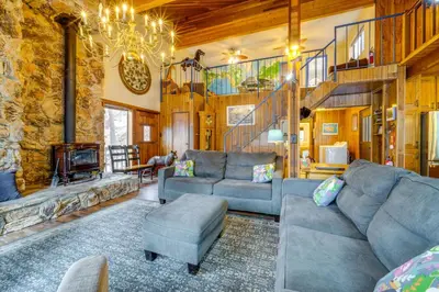 a living room with a couch and a fireplace at Waterfront Truckee Cabin on Donner Lake! in Truckee