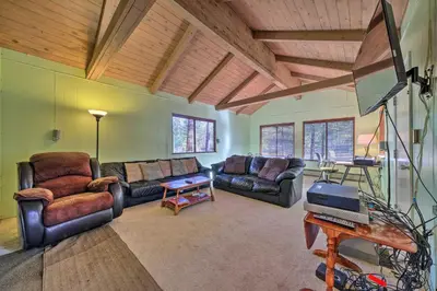 a living room with leather furniture and a flat screen tv at 6 Mi to Yosemite Natl Park 14-Acre Retreat! in Groveland