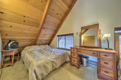 a bedroom with a bed and a dresser and a mirror at 6 Mi to Yosemite Natl Park 14-Acre Retreat! in Groveland