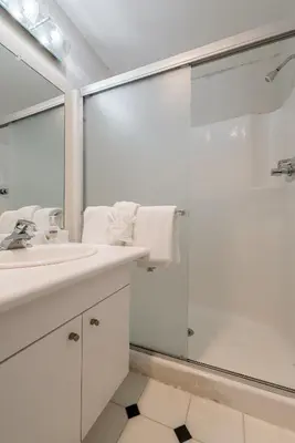 a white bathroom with a sink and a shower at Chamonix # 62 in Mammoth Lakes