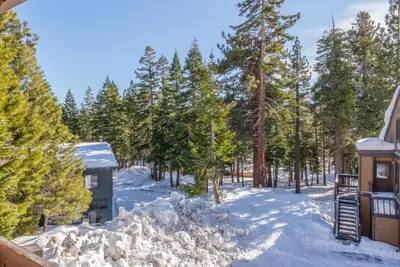 a house in the snow with trees in the background at Bigwood W #90 in Mammoth Lakes