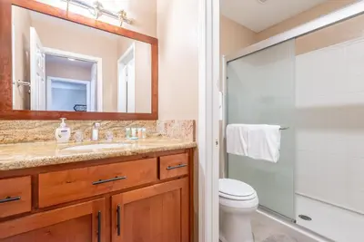 a bathroom with a sink and a toilet and a mirror at Bigwood W #90 in Mammoth Lakes