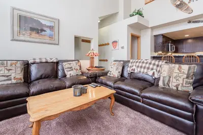 a living room with leather couches and a coffee table at Snowcreek #856 Phase V in Mammoth Lakes