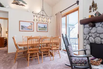 a dining room with a table and chairs and a fireplace at Snowcreek #856 Phase V in Mammoth Lakes