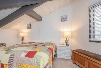 a bedroom with a bed and two lamps and a window at Sierra Park Villas N-#66 in Mammoth Lakes