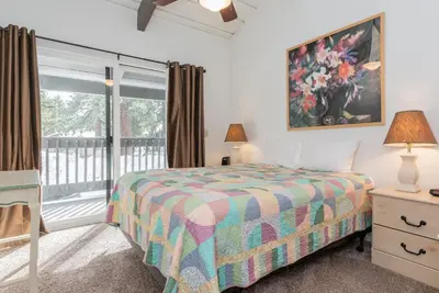 a bedroom with a bed and a large window at Sierra Park Villas N-#66 in Mammoth Lakes