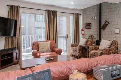 a living room with a couch and chairs and a tv at Sierra Park Villas N-#66 in Mammoth Lakes