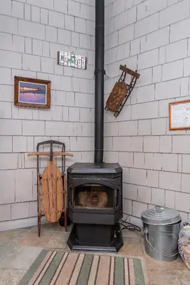 a stove in a room with a brick wall at Sierra Park Villas N-#66 in Mammoth Lakes