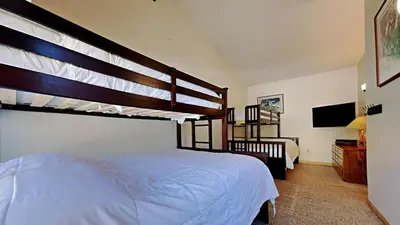 a bedroom with a bunk bed and a television at Spectacular 3 Bedroom Townhome with Pool in Mammoth Lakes