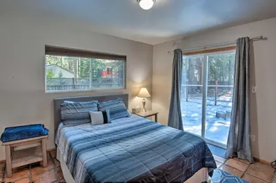 a bedroom with a bed and a large window at 7 Mi to Heavenly Ski Resort Cozy Tahoe Cabin in South Lake Tahoe