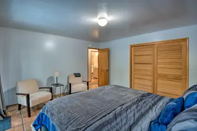 a bedroom with a bed and two chairs and a table at 7 Mi to Heavenly Ski Resort Cozy Tahoe Cabin in South Lake Tahoe