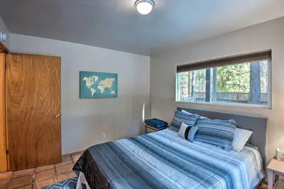 a bedroom with a bed and a window at 7 Mi to Heavenly Ski Resort Cozy Tahoe Cabin in South Lake Tahoe