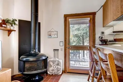 a kitchen with a stove in the middle of a room at Ski-InandSki-Out Northstar Condo Near Lake Tahoe! in Truckee