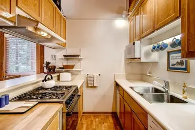 a kitchen with a sink and a stove top oven at Ski-InandSki-Out Northstar Condo Near Lake Tahoe! in Truckee